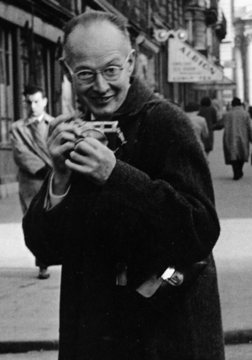 Henri Cartier-Bresson holding his Leica camera.